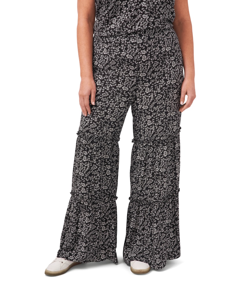 Front of a model wearing a size 1X Laney Floral Print Ruffle Pant in 060-RICH BLACK by CeCe. | dia_product_style_image_id:263555